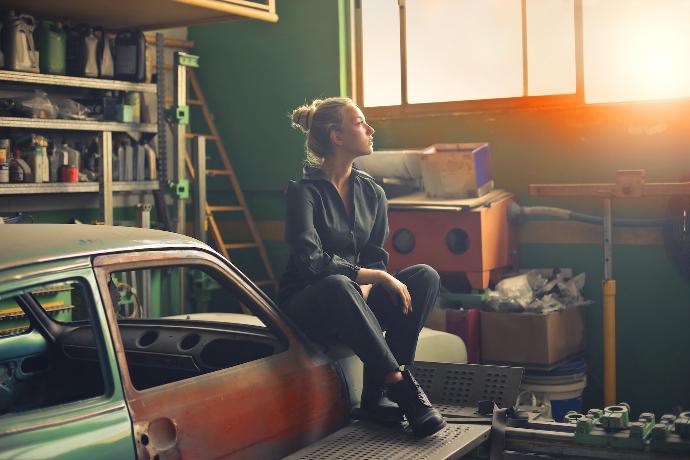 woman sitting on orange vehicle